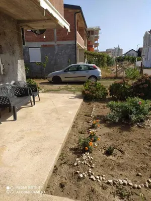 a car parked in a parking lot with a garden at Dax in Ulcinj
