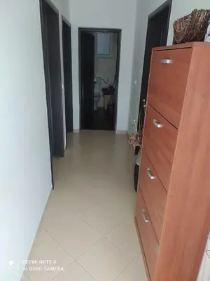 a room with a wooden dresser and a hallway at Dax in Ulcinj