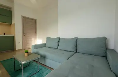 a living room with a blue couch and a table at DERON Apartments in Ulcinj