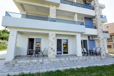 a house with chairs on a patio at DERON Apartments in Ulcinj