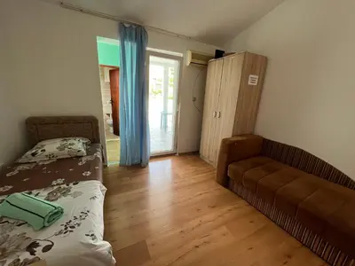 a bedroom with a bed and a couch in a room at Green Villa in Bar, Susanj