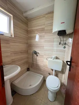 a bathroom with a white toilet and a sink at Green Villa in Bar, Susanj
