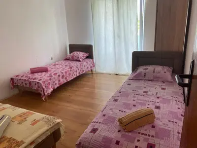 two beds in a room with pink sheets on them at Green Villa in Bar, Susanj