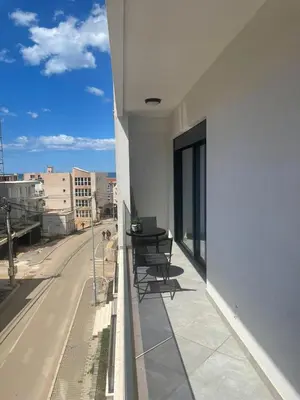 a balcony with chairs and a view of a street at French Mood in Dobra Voda