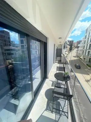a balcony with chairs and a table on a building at French Mood in Dobra Voda
