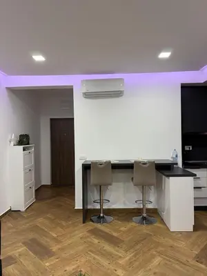 a kitchen with a counter and stools in a room at French Mood in Dobra Voda