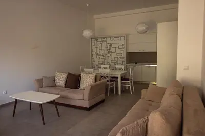 a living room with a couch and a table at Vertmont Apartments in Sveti Stefan