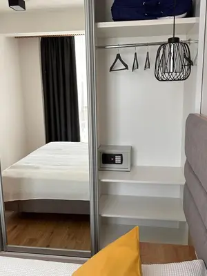 a mirror in a small bedroom with a bed at Мamma Mia Аpartments in Budva